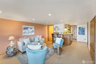 Lower level living space with breakfast bar, sink & dishwasher. Built-ins to the right as well as a bedroom and a bonus room. Straight ahead is lower level laundry (there is a main floor one too) and doorway to the left is the full bath.