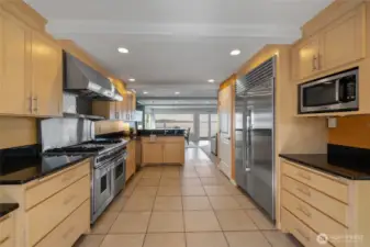 A true chefs kitchen with Wolf range/double oven & sub-zero fridge.
