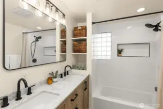Renovated Main Level Full Bath features new quartz dual sink vanity, ceramic tile flooring, new subway tile and updated fixtures.