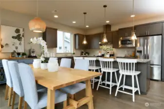 The kitchen features a large, 4-chair island and generous dining space.