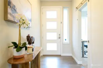 The light filled entry opens to gleaming engineered hardwood floors and a stylish den/office with barn door.
