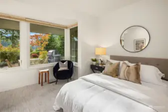 The two downstairs bedrooms are thoughtfully secluded from the main living areas, offering a tranquil oasis surrounded by lush, meticulously landscaped gardens.