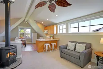 The apartment's main living area. Note the free-standing propane fireplace. Electric heat is also available.