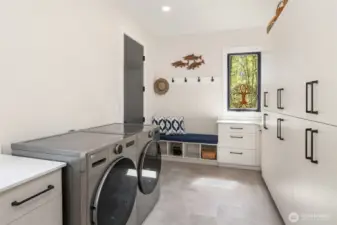 Laundry room/mud room space with access to the garage.  So much storage!!!