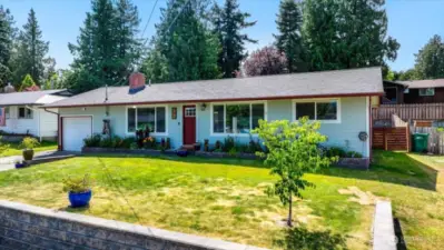 Front yard with flower beds along the front of the home.