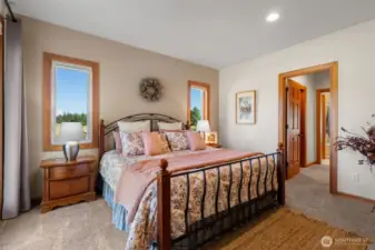 Primary ensuite featuring Xtrodinair fireplace & custom closets.