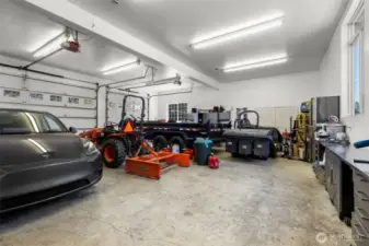 Oversized 3 car garage with work space.