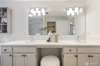 Double sinks and seating, plus a linen closet.