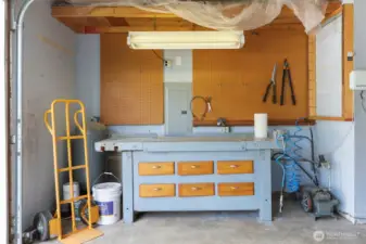 Even space for a little workshop - and don't miss the exterior closet just right to stow yard tools outside of the garage!