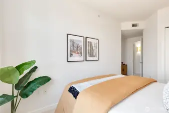The bedroom is off the hall, with a full bath just outside the door. There is also an inset area next to the door for a cabinet or dresser if desired.