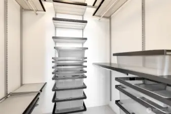 This closet has a customizable organizational system from the container store- shelves, drawers, and bins can be moved around and adjusted as desired.