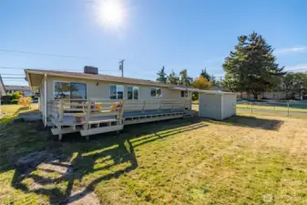 The spacious back yard has a large hardwood deck, an extra carport and storage area and plenty of room for gardening or yard games.