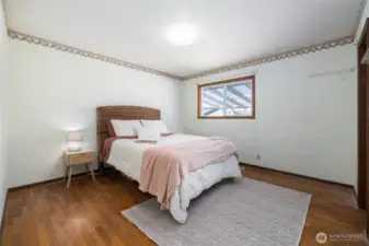 Primary bedroom with a walk in closet and attached 3/4 bath.