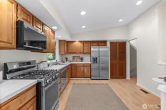 This layout offers a refreshing sense of scale. By prioritizing wide-open floor space, the kitchen feels exceptionally airy, highlighting the seamless run of custom woodwork and the sophisticated, durable countertops.