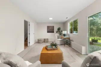 This expansive lower level is engineered for leisure. Whether you’re coming in from the garage or stepping out to the deck, the space remains bright and inviting, functioning as a private media room or a casual garden-side lounge.