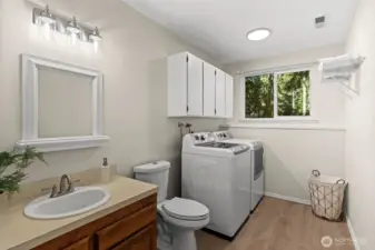 This bottom-level living room offers a strategic 'mudroom' flow from the garage, while offering simplicity and easy transitions throughout the entire home.