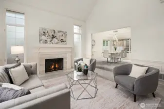 Soaring vaulted ceilings, a classic fireplace, and an abundance of natural light create an elegant yet inviting formal living room — perfect for entertaining or quiet relaxation.