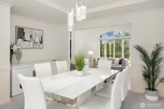 Bathed in natural light from oversized windows, this gracious dining room offers ample space for entertaining, with refined details and a seamless connection to the main living areas.