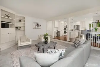 The family room flows effortlessly into the chef's kitchen beyond, offering an ideal open-concept layout perfect for both everyday living and entertaining guests.