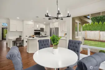 This bright and airy dining nook connects seamlessly to the chef's kitchen and overlooks the private backyard, offering a relaxed yet stylish space for casual meals and morning coffee.