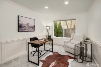 The dedicated main level office offers a quiet, light-filled workspace with a large window and flexible layout, easily convertible to a 5th bedroom to suit your needs.