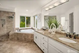 The luxurious primary bath impresses with dual vanities, a deep soaking tub, and beautiful tile work throughout, a true spa-inspired escape designed for relaxation and everyday indulgence.
