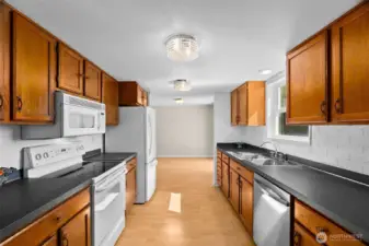 The galley kitchen features wood cabinetry, a brand new dishwasher, and beautiful views of the valley.