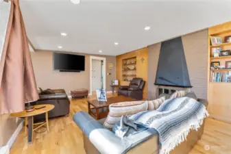 Another angle of living room with wood burning fire place