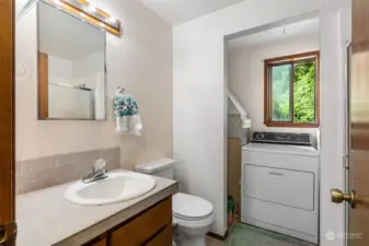 Main floor bathroom with shower and washer and dryer