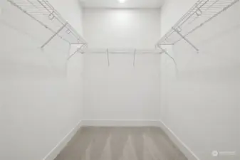 Spacious primary closet. Features and finishes may vary. For marketing use only