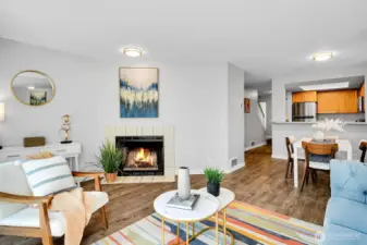 Living room featuring upgraded flooring and lighting.  Cozy evenings by the wood burning fireplace.
