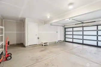 Spacious 2 car garage with additional storage closet and storage nooks