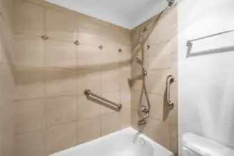 Tile bath tub surround.  Extra grab bars to keep you safe.  Custom shower wand recently installed.