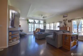 Another view of the spacious living room filled with comfort and charm.