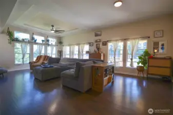 Bright living room filled with natural light from an abundance of windows.