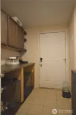 Laundry room with plenty of cabinets for storage and organized functionality.