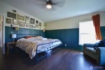 Another view of the large primary bedroom highlighting its generous space and cozy ambiance.