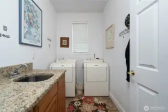 The laundry room is located on the main floor and features a sink and ample counter space
