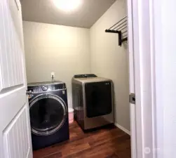 Ample Laundry room with shelves