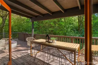 This portion of the deck is covered so you can enjoy nature and outdoor dining all year long.