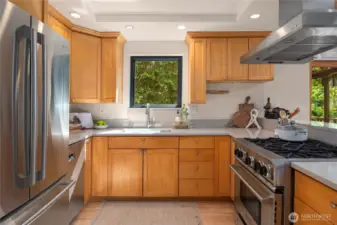 Stainless appliances play nicely off the natural wood cabinets with full-height uppers.