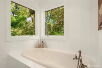 This soaking tub features 2 windows with nothing but nature looking in.