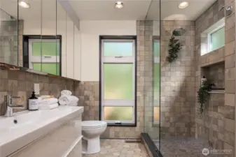 The main floor bath features extensive custom tile work and an oversized walk-in shower.