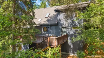 Looking towards the main floor entrance and the expansive deck on the south side of the house.