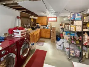 Calling all tinkerers, crafters, and bulk buyers — this basement utility area delivers. With a full-length workbench, ample cabinetry, and tons of open shelving, you’ll have a spot for every tool, tote, and pantry item. Whether you’re building, storing, or just staying organized, this is your behind-the-scenes MVP.