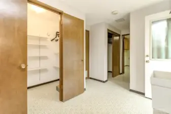 Utility room with walk-in pantry, entrance to garage, entrance to backyard and half bath and office.
