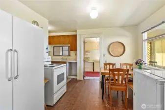 The kitchen has a door leading to the enclosed porch where you can access the back of the house and alley or the front porch.