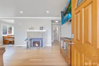 Welcome into this lovely living space with crown molding, stylish gas fireplace, and newer hardwood floors that continue throughout the downstairs.