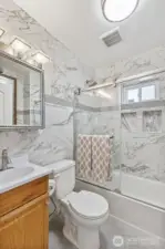 Downstairs full bath has been pleasantly updated with gorgeous tile.