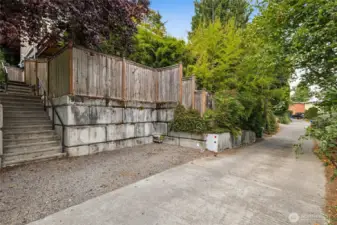 Lower slope of the property. Dedicated parking spot, ten steps up to the East Entry.